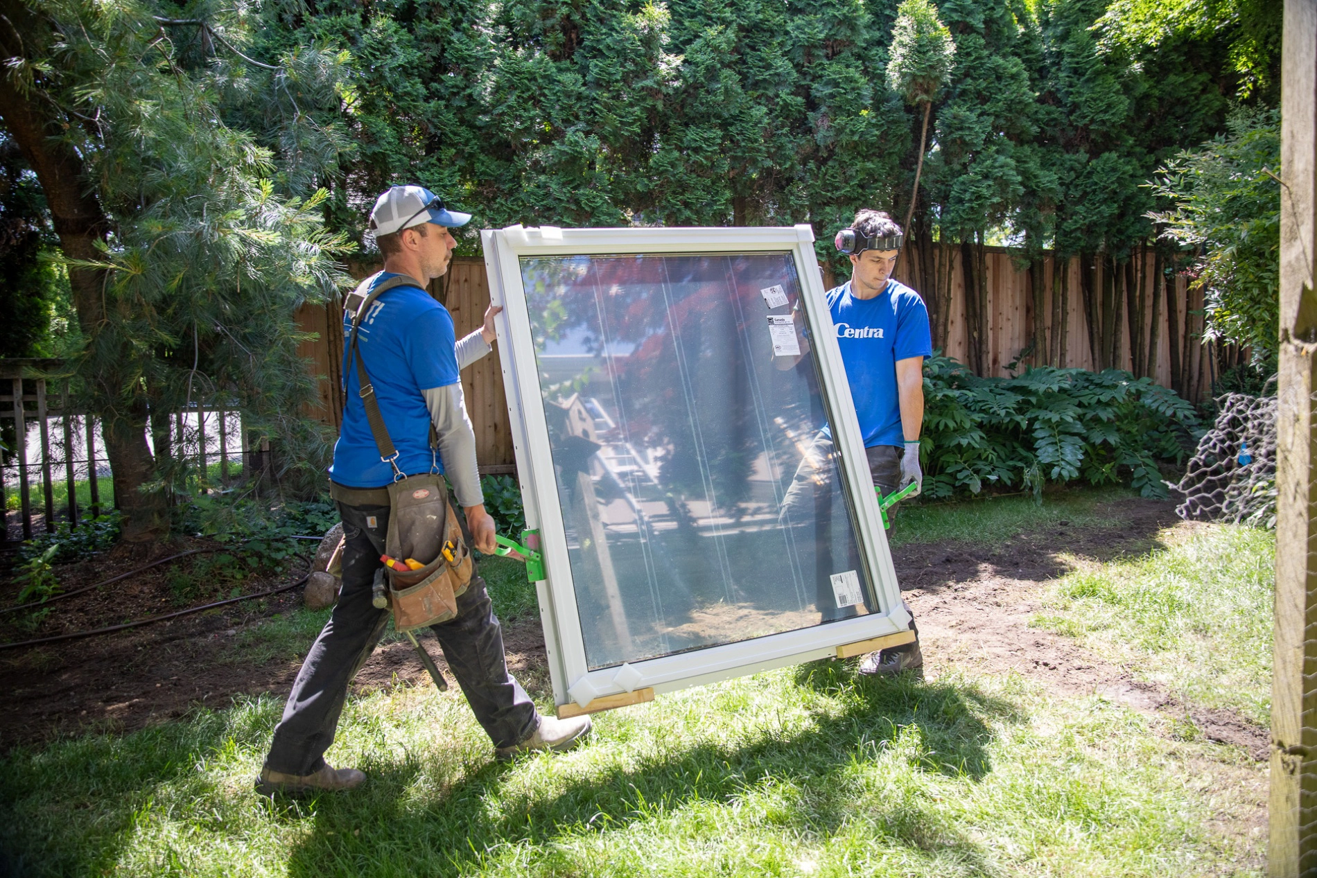 Window installers carrying a window